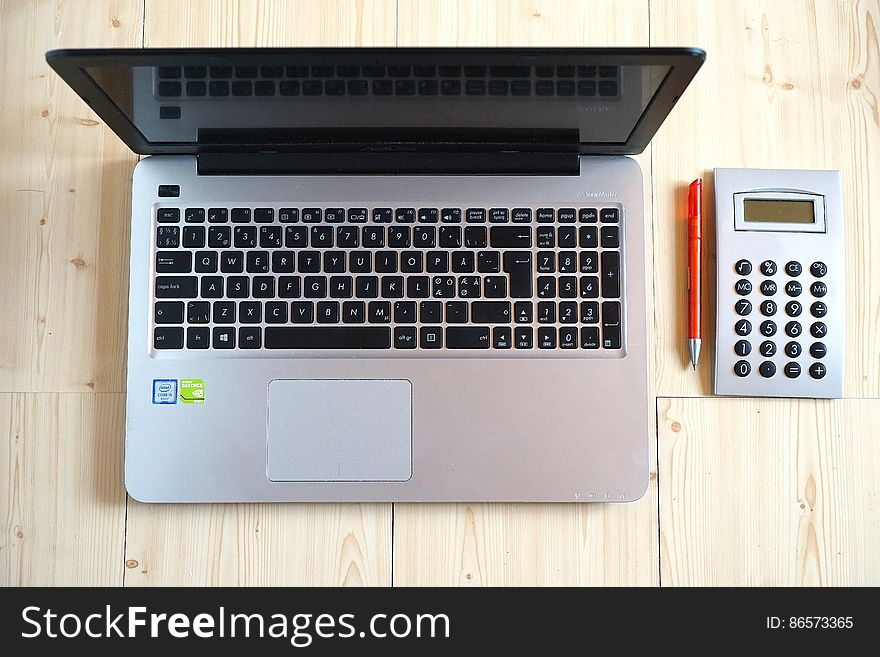 Macbook Pro Beside Gray Rectangular Device