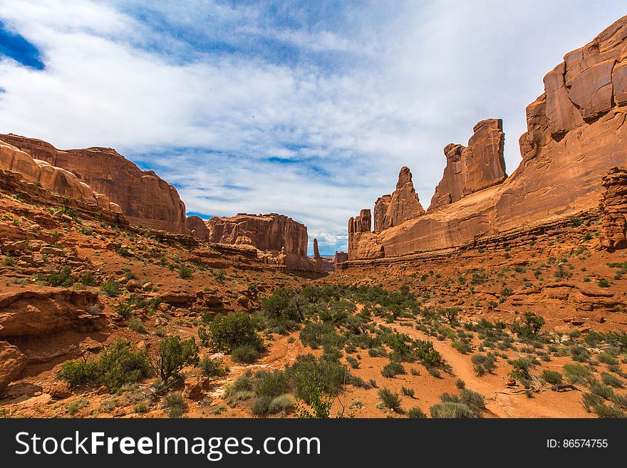 Desert landscape with sandstone rock formations against blue skies on sunny day. Desert landscape with sandstone rock formations against blue skies on sunny day.