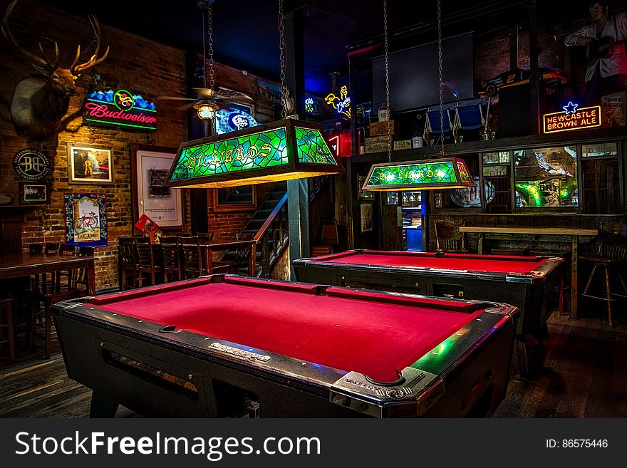 Interior of empty pool hall with vintage lights and neon signs. Interior of empty pool hall with vintage lights and neon signs.