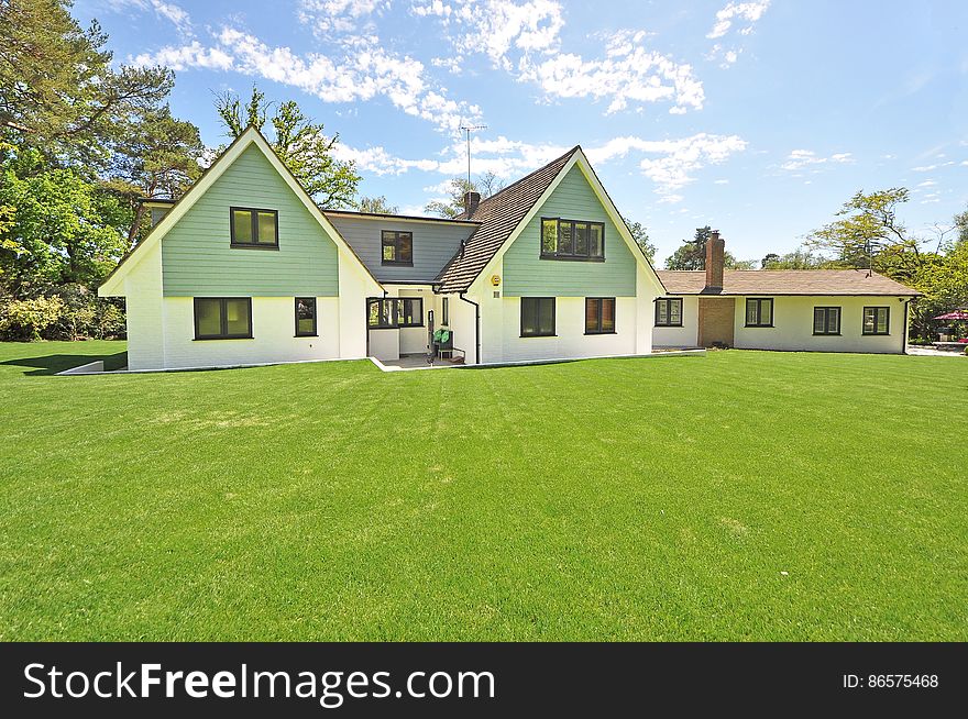 A modern bungalow with a huge lawn in front. A modern bungalow with a huge lawn in front.