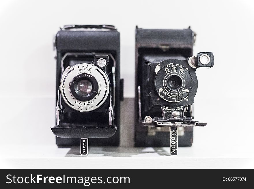 Vintage cameras on shelf in black and white. Vintage cameras on shelf in black and white.