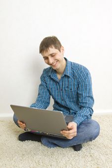 Man Sitting On The Floor Using A Laptop Royalty Free Stock Images