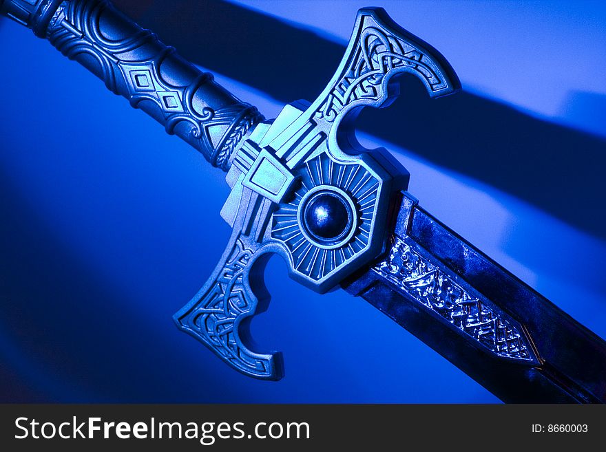 Photo of sword diagonally with a blue background. Photo of sword diagonally with a blue background