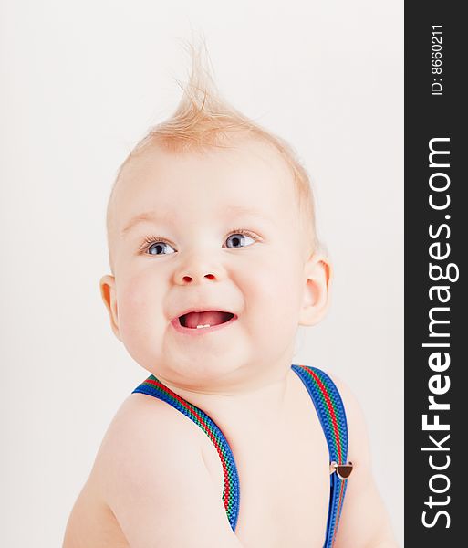 Small boy in blue suspenders on white background. Small boy in blue suspenders on white background