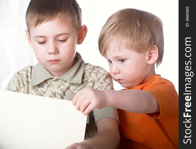 Two boys play on a white background. Two boys play on a white background