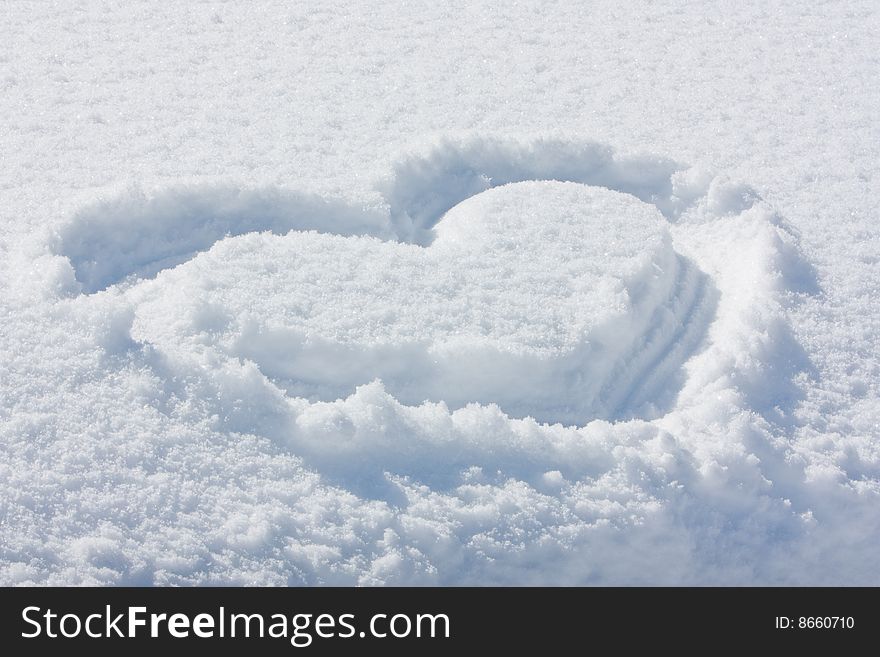 Heart symbol in the snow. Heart symbol in the snow.