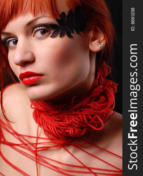 Young woman with red clew on her neck