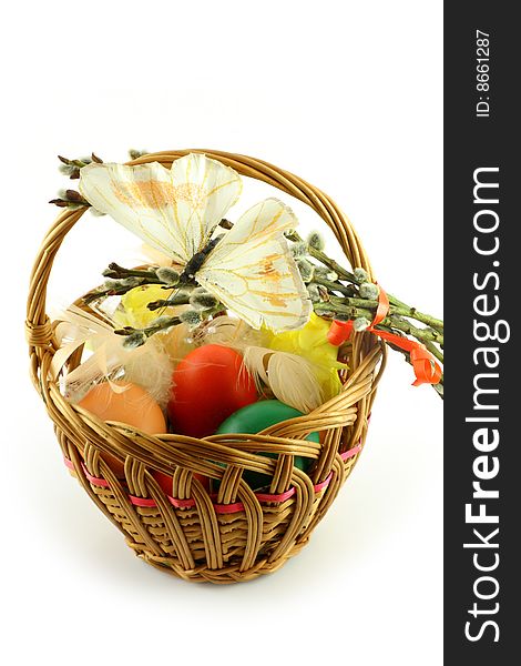 Easter basket, with  colored eggs, over white background