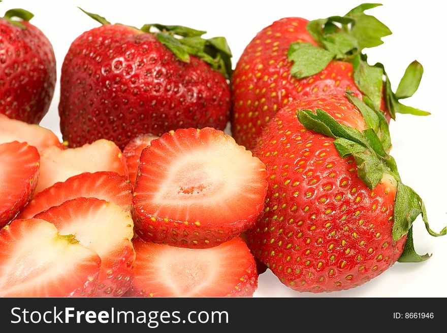 Strawberries, whole and sliced, isolated on white. Strawberries, whole and sliced, isolated on white