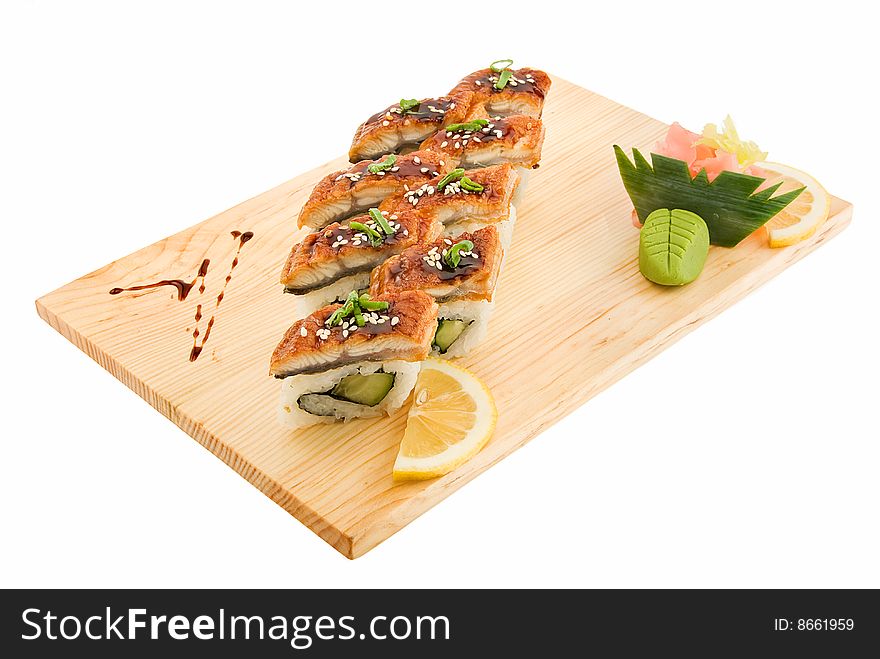 Appetizing aromatic rolls on wooden plate isolated. Appetizing aromatic rolls on wooden plate isolated