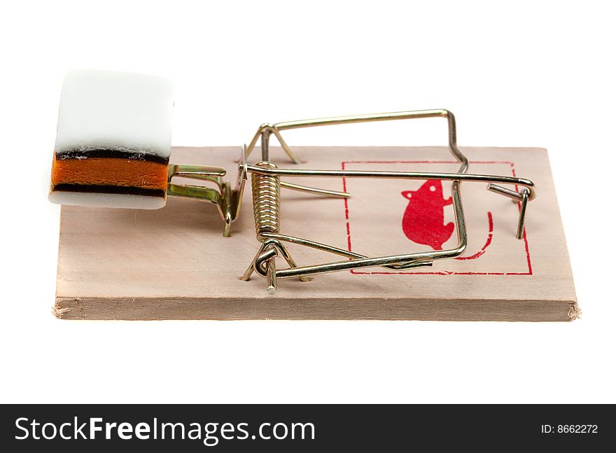 Conceptual image of candy on a mouse trap isolated on a white background