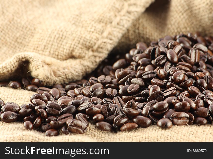Coffee beans rolled out of a canvas bag. Coffee beans rolled out of a canvas bag