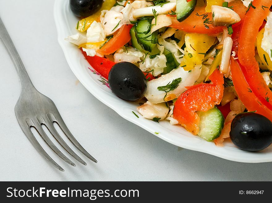 Stock photo: an image of fork and fresh salad on the plate. Stock photo: an image of fork and fresh salad on the plate