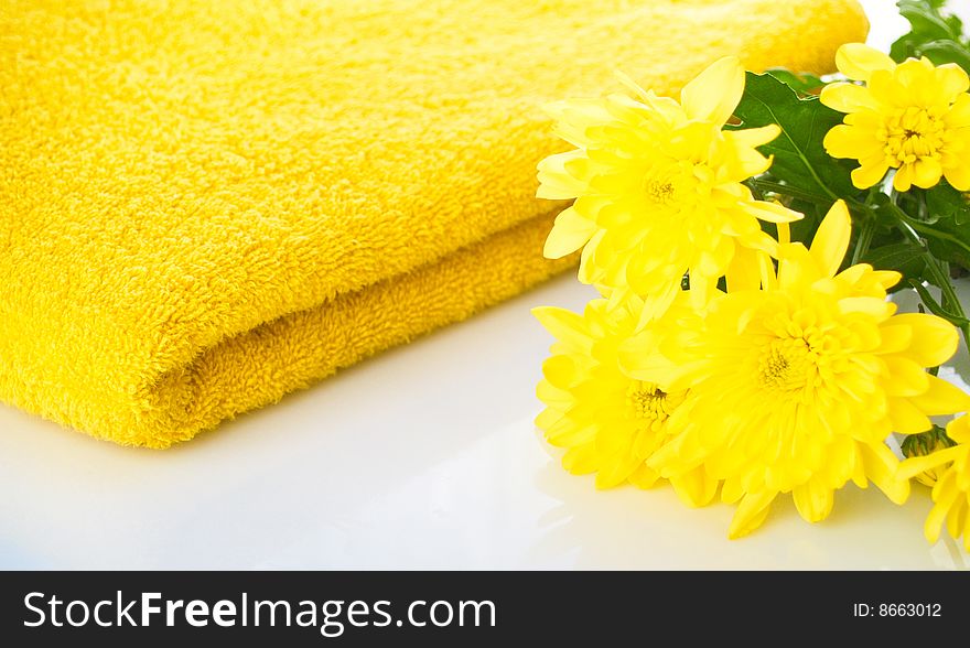 Composition from a towel and  yellow flower