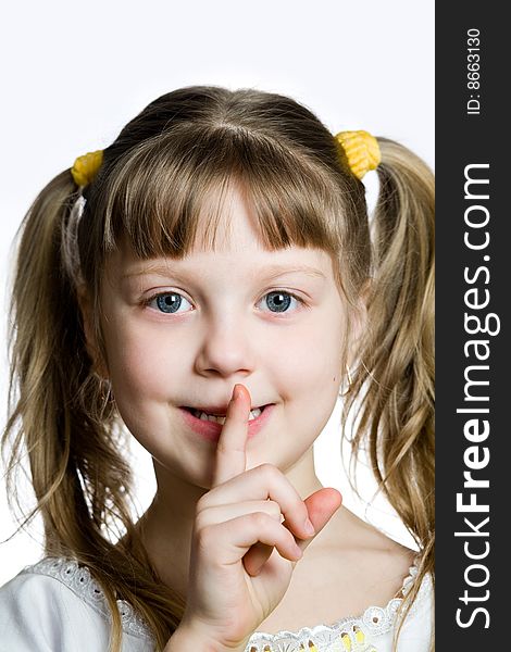 An image of a girl with a finger on her lips. An image of a girl with a finger on her lips