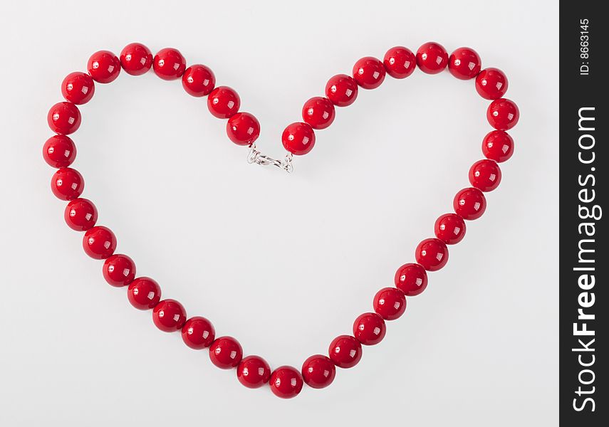 Red mardi gras beads in the form of heart. Red mardi gras beads in the form of heart