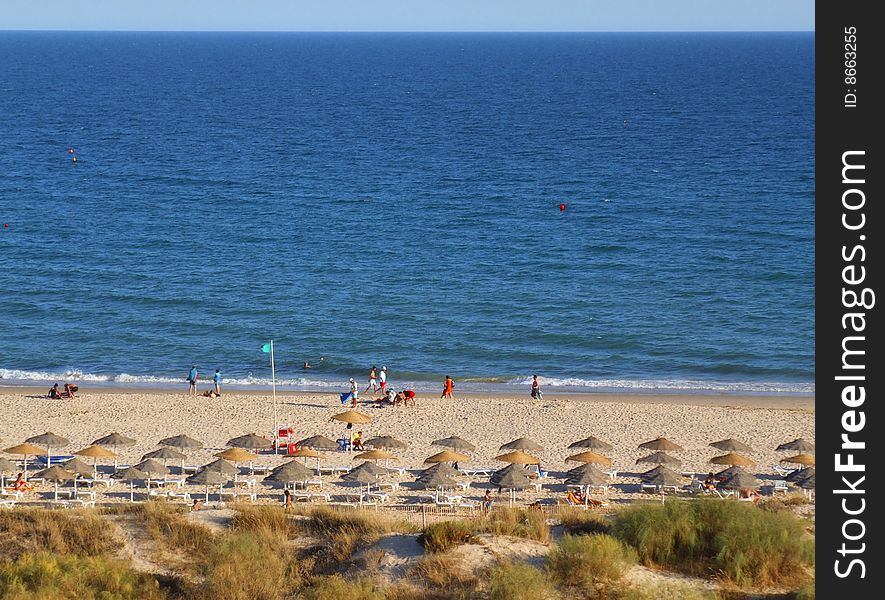 Nice beach, with blue sea and straw sunshades. Nice beach, with blue sea and straw sunshades
