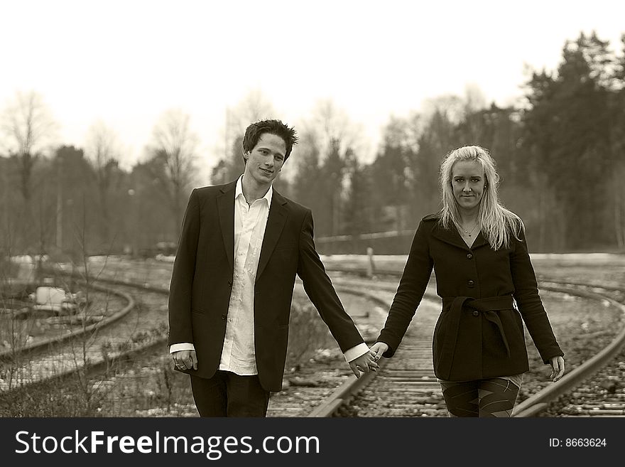 Couple going at a railway track