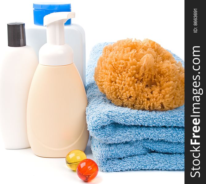 Body care products and towel on white background