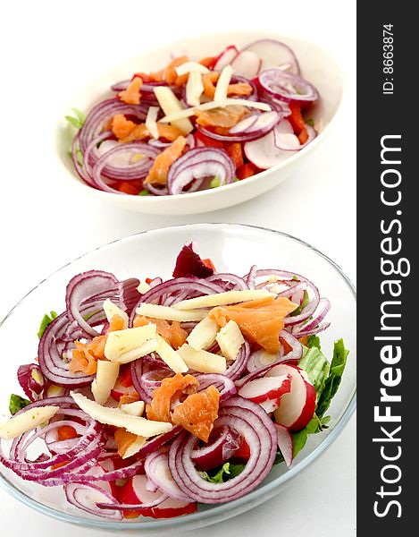 Two salad plates on white background, focus on first salad