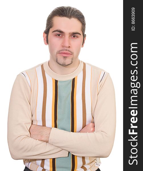 Serious dark haired caucasian man with hands folded on chest in striped sweater isolated. Serious dark haired caucasian man with hands folded on chest in striped sweater isolated