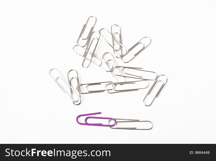 Paperclips on white office desk.