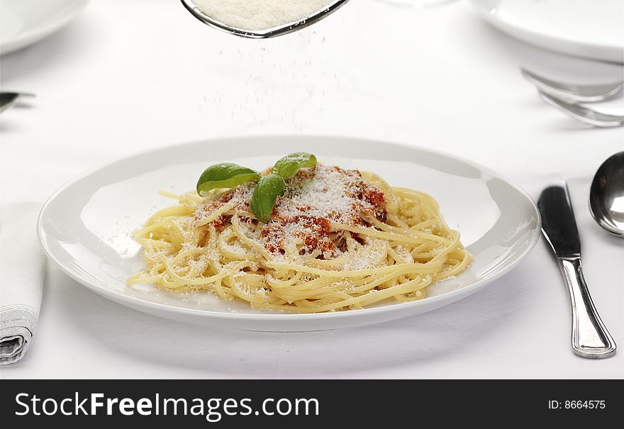 Pasta with tomato sauce basil and grated parmesan