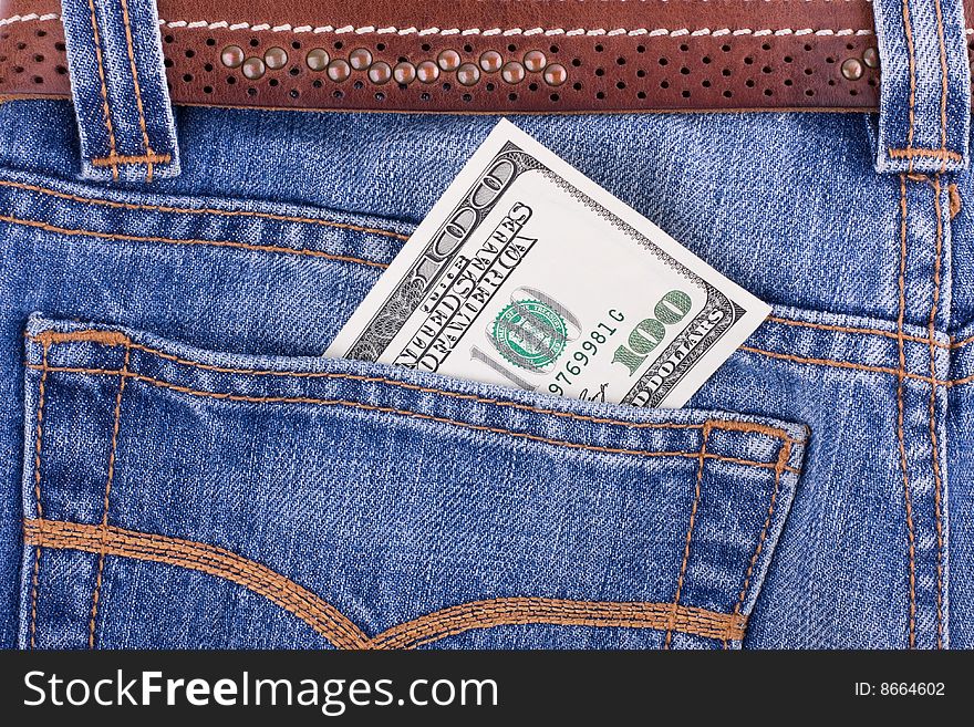 Hundred dollar bill in pocket of blue jeans