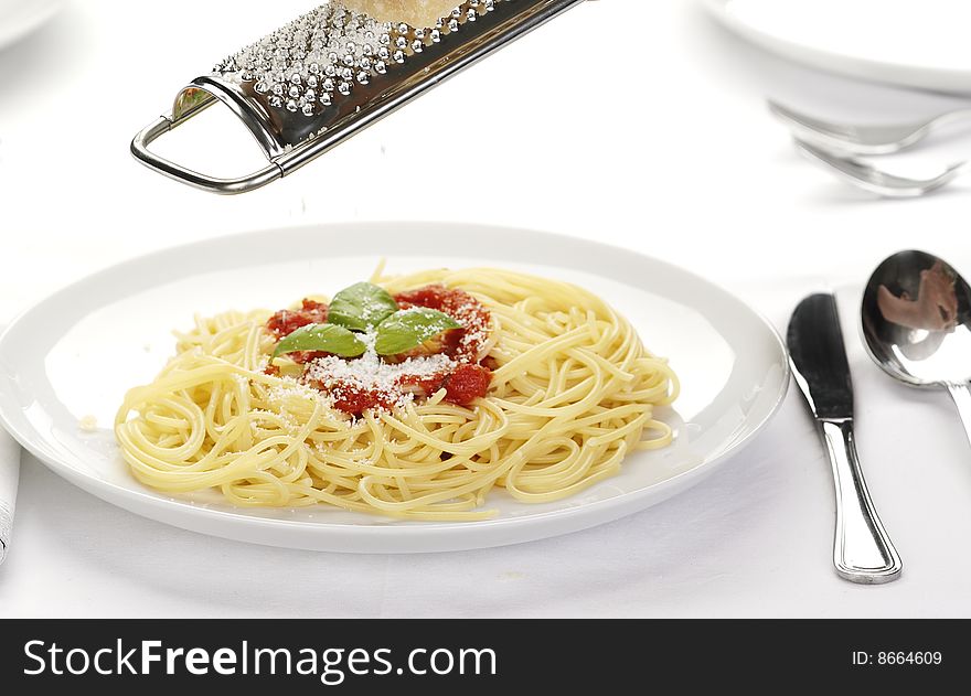 Pasta with tomato sauce basil and grated parmesan