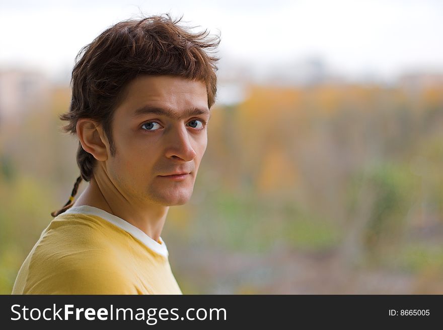 The surprised young man in a yellow T-shirt.