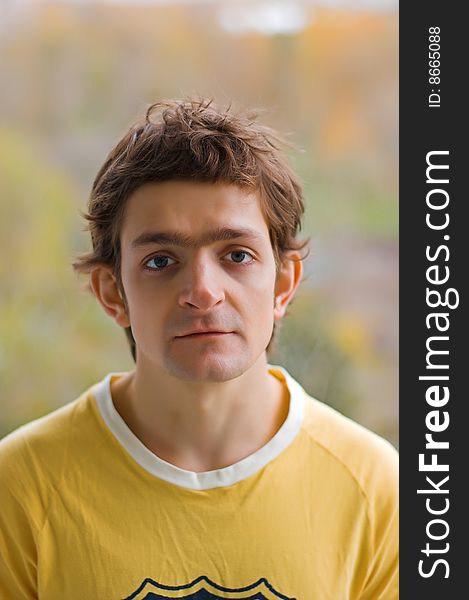 The upset young man in a yellow T-shirt. The upset young man in a yellow T-shirt.