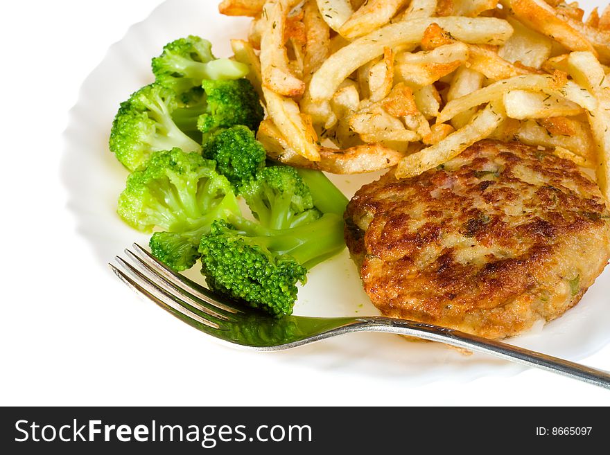 Close-up cutlet with broccoli and potatoes on plate, isolated