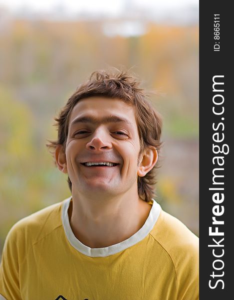 The laughing young man in a yellow T-shirt. The laughing young man in a yellow T-shirt.