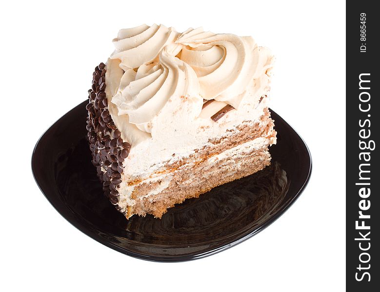 Close-up piece of cake on black plate, isolated