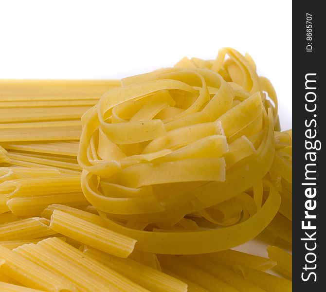 Various shapes of pasta on white background