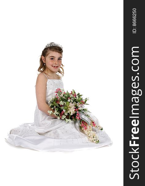 Pretty girl in tiara and white gown holding bouquet of flowers. Pretty girl in tiara and white gown holding bouquet of flowers