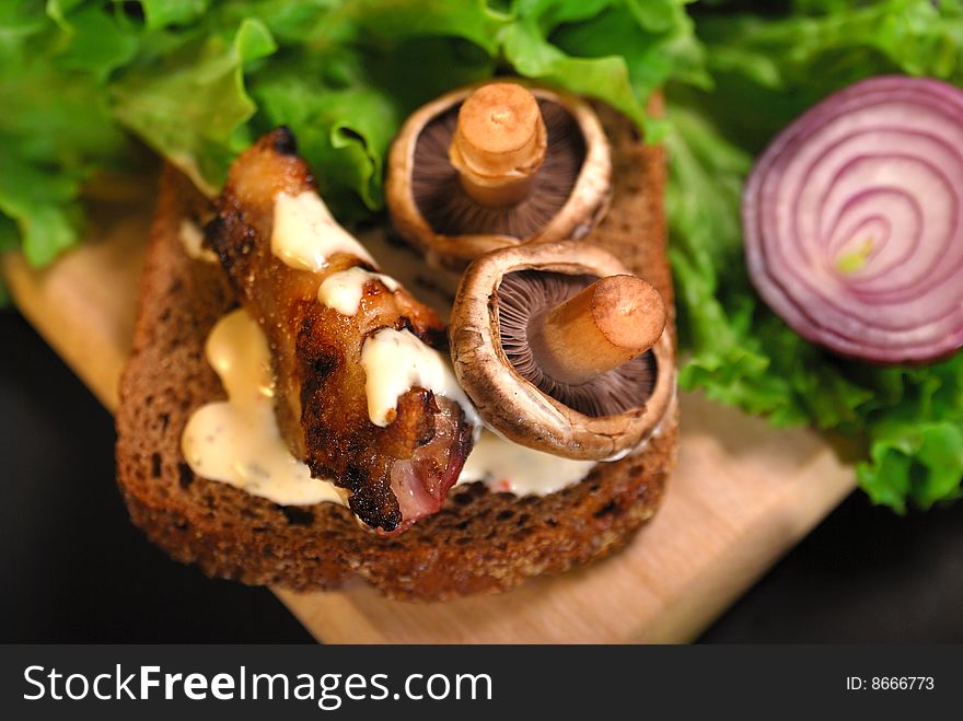 Mushroom and  grilled meat on a lettuce. tasty food. Mushroom and  grilled meat on a lettuce. tasty food