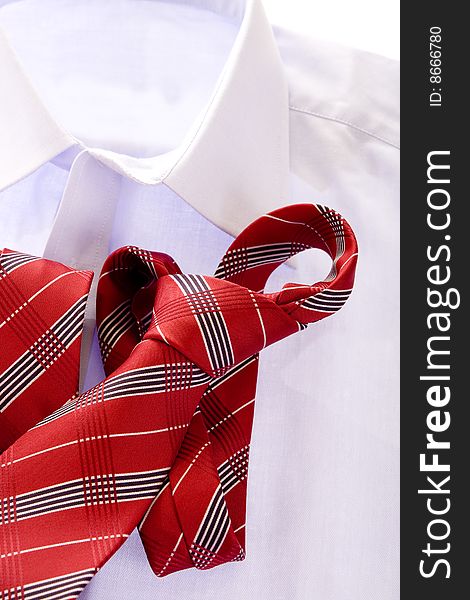 Blue shirt and red tie on white