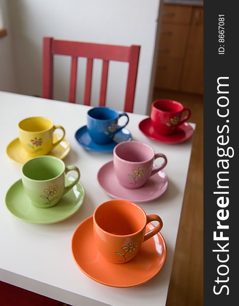 Coloured cups on a table