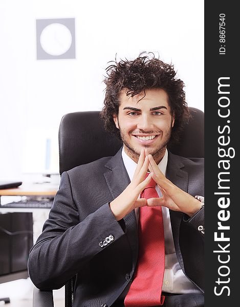 Businessman in the office, smiling and looking in camera