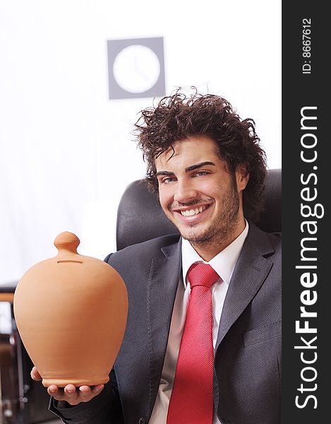 Businessman in the office, smiling and looking in camera. Businessman in the office, smiling and looking in camera