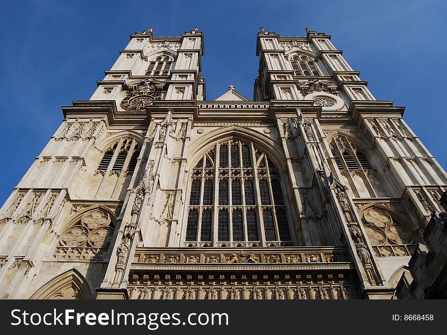 Upward perspective view of the front facade of Westminster Abbey in London, England