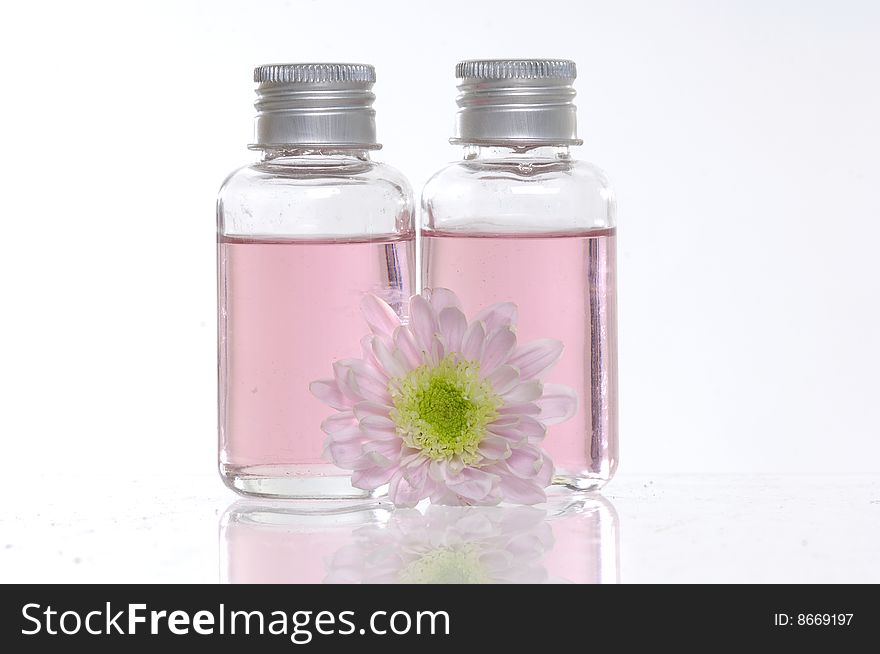 Spa bottles and daisies isolated on white. Spa bottles and daisies isolated on white