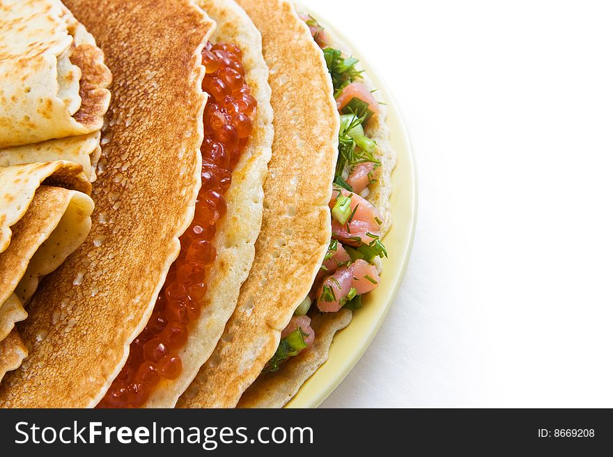 Russian pancakes with a stuffing from red caviar and a salmon (top left view). Russian pancakes with a stuffing from red caviar and a salmon (top left view)