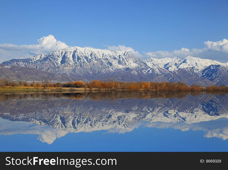 Mountains Reflected into a lake in the spring. Mountains Reflected into a lake in the spring
