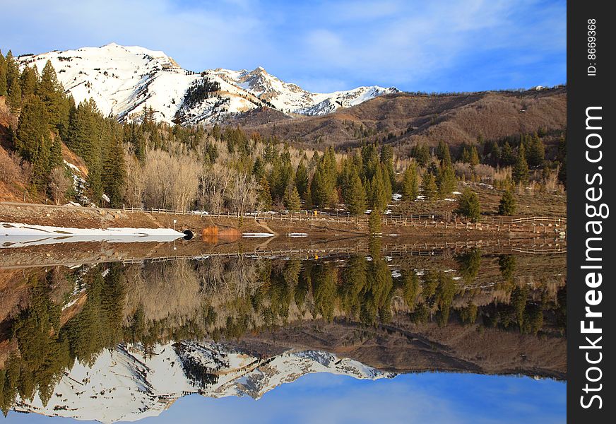 Mountains Reflected into a lake in the spring. Mountains Reflected into a lake in the spring