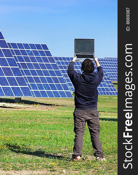 Young man in Central of photovoltaic panels. Young man in Central of photovoltaic panels.