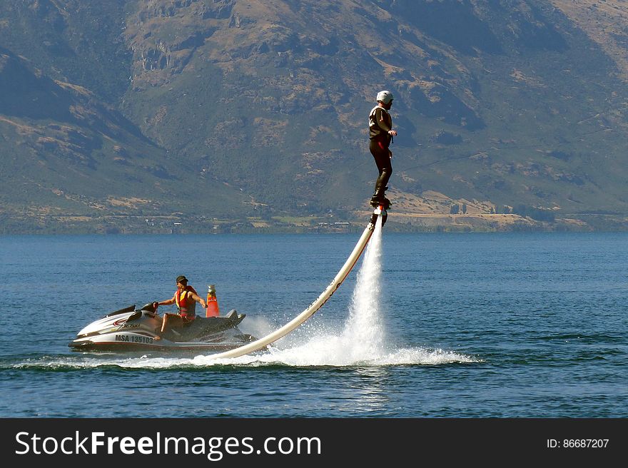 A Flyboard is a type of water jetpack attached to a personal water craft &#x28;PWC&#x29; which supplies propulsion to drive the Flyboard through air and water to perform a sport known as flyboarding. A Flyboard rider stands on a board connected by a long hose to a watercraft. Water is forced under pressure to a pair of boots with jet nozzles underneath which provide thrust for the rider to fly up to 15 metres in the air or to dive headlong through the water. A Flyboard is a type of water jetpack attached to a personal water craft &#x28;PWC&#x29; which supplies propulsion to drive the Flyboard through air and water to perform a sport known as flyboarding. A Flyboard rider stands on a board connected by a long hose to a watercraft. Water is forced under pressure to a pair of boots with jet nozzles underneath which provide thrust for the rider to fly up to 15 metres in the air or to dive headlong through the water.