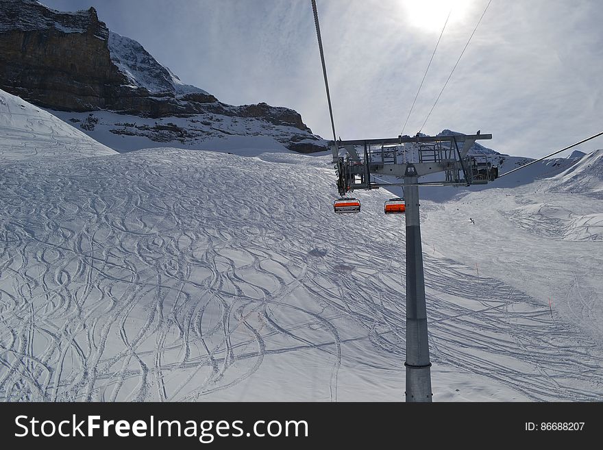 Ski Lift On Snowy Landscape