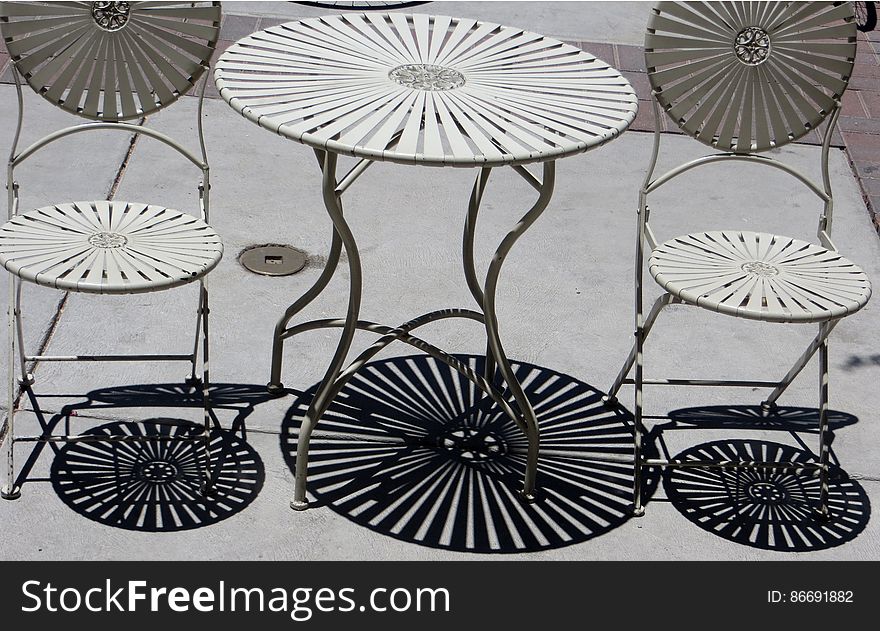 shadows of metal table and chairs